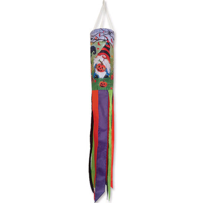 Halloween Gnomes windsock featuring embroidered gnomes, a cauldron, jack-o'-lanterns, and autumn leaves, displayed outdoors catching the wind.