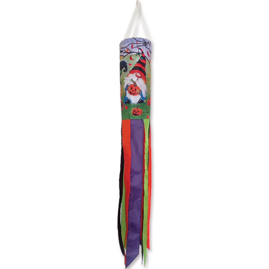 Halloween Gnomes windsock featuring embroidered gnomes, a cauldron, jack-o'-lanterns, and autumn leaves, displayed outdoors catching the wind.