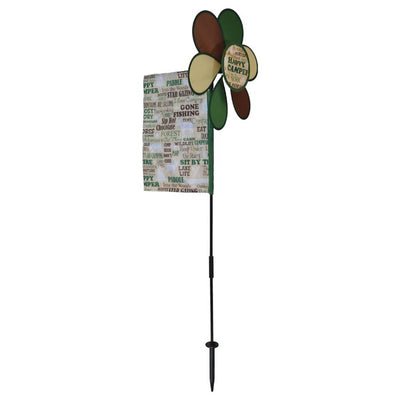 Happy Camper Flower Spinner with colorful camping flag in a garden setting, featuring a vibrant flower design and pivoting pole.