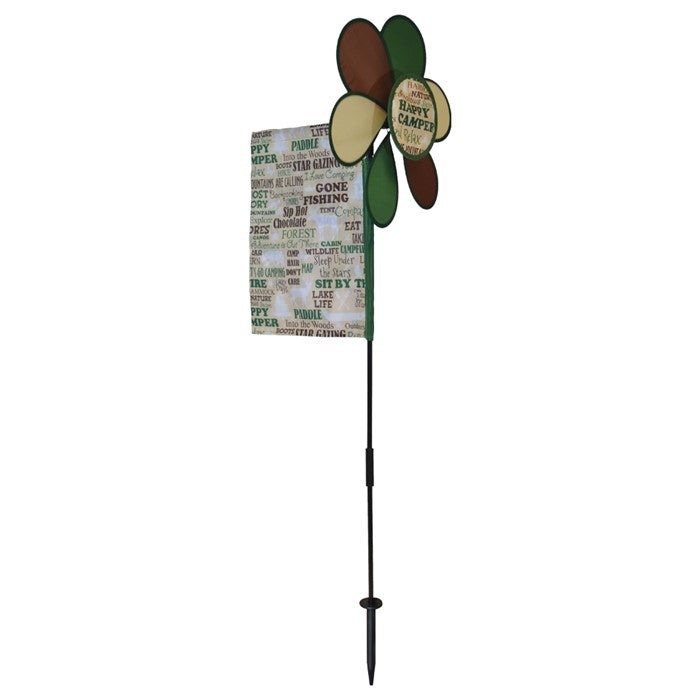 Happy Camper Flower Spinner with colorful camping flag in a garden setting, featuring a vibrant flower design and pivoting pole.