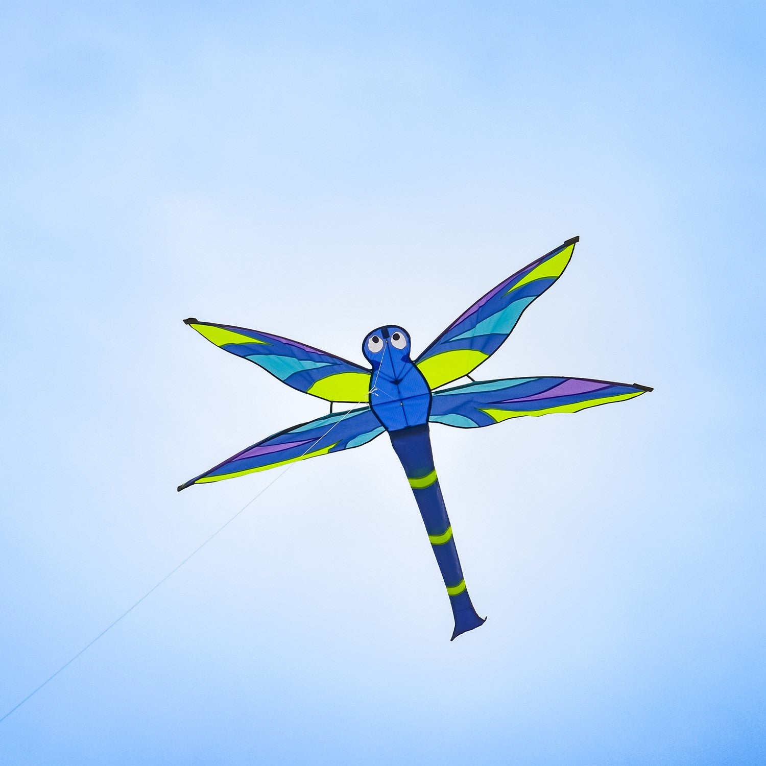 Vibrant Harmony Dragonfly Kite soaring through a clear blue sky, showcasing intricate details and fluttering wings in the wind.