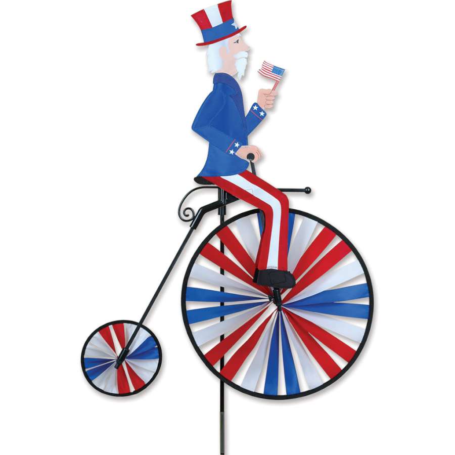High Wheel Bike Spinner featuring Uncle Sam design in a colorful, spinning display set against a garden backdrop.