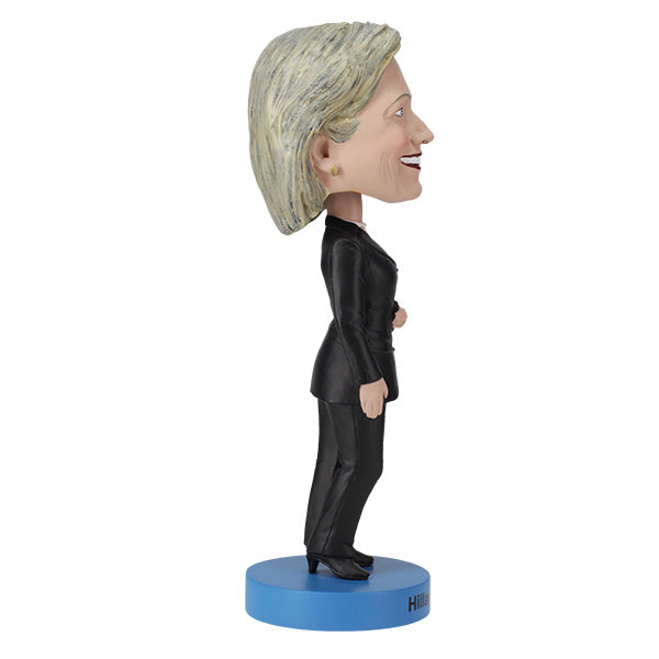 Hillary Clinton 2016 bobblehead, standing approximately 8 inches tall, capturing her likeness in vibrant detail, displayed on a shelf.