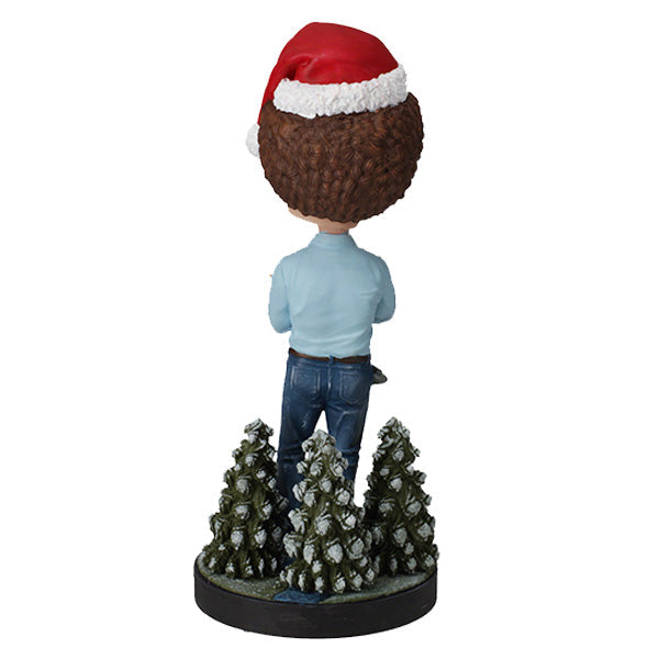 Holiday Bob Ross Bobblehead featuring Bob Ross in a winter sweater, approximately 8 inches tall, smiling joyfully.