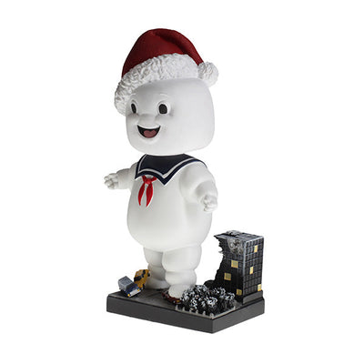 Holiday Ghostbusters Stay Puft Bobblehead with festive Santa hat, measuring 7 inches, showcased among Christmas decorations.