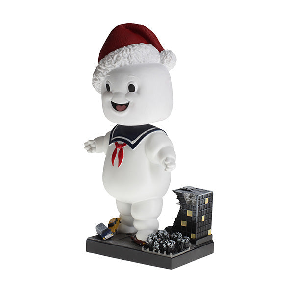 Holiday Ghostbusters Stay Puft Bobblehead with festive Santa hat, measuring 7 inches, showcased among Christmas decorations.