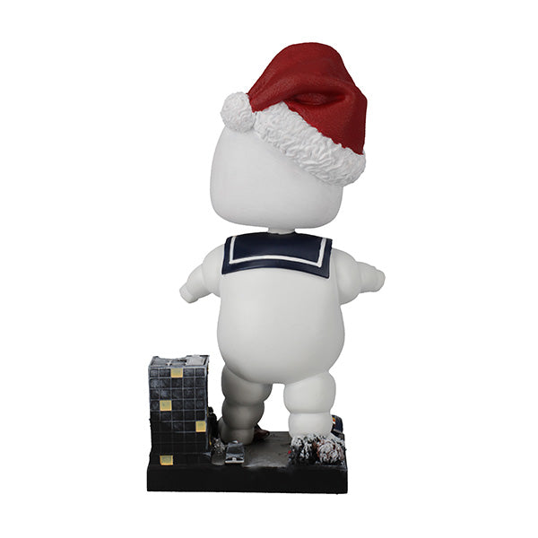 Holiday Ghostbusters Stay Puft Bobblehead with festive Santa hat, measuring 7 inches, showcased among Christmas decorations.