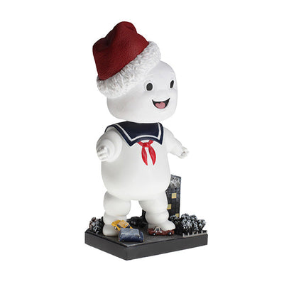Holiday Ghostbusters Stay Puft Bobblehead with festive Santa hat, measuring 7 inches, showcased among Christmas decorations.