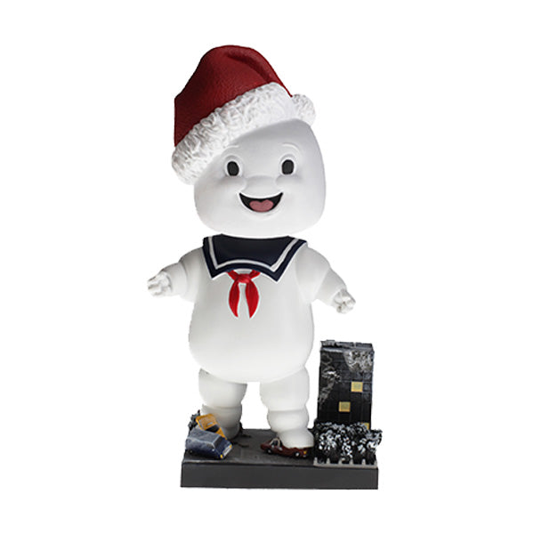 Holiday Ghostbusters Stay Puft Bobblehead with festive Santa hat, measuring 7 inches, showcased among Christmas decorations.