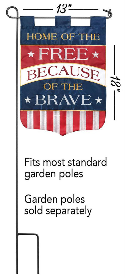 Home of the Free Because of the Brave 13x18 garden flag displayed on a decorative stand, showcasing its bold design and durable weatherproof polyester.