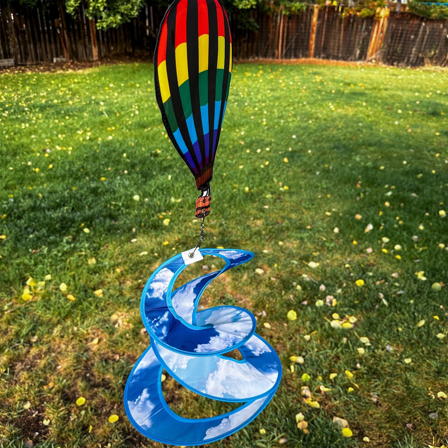 Colorful Hot Air Balloon Theme Duet spinner hanging outdoors, featuring a vibrant hot air balloon design that spins beautifully in the wind.