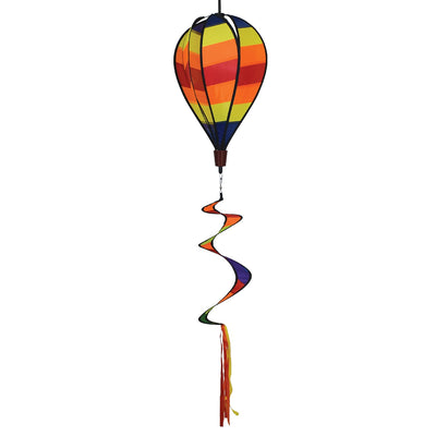 Hot Stripe Hot Air Balloon spinner with bright striped design in motion, hanging in a garden setting against a blue sky.