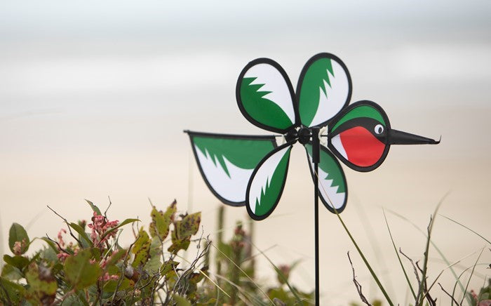 Hummingbird Baby Spinner with colorful design displayed outdoors, showcasing a vibrant baby hummingbird spinning in the garden.