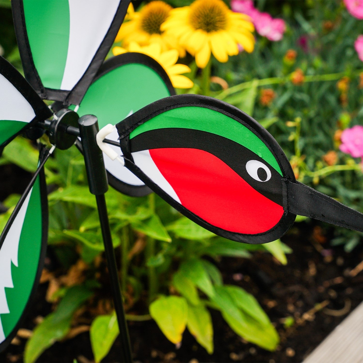 Hummingbird Baby Spinner with colorful design displayed outdoors, showcasing a vibrant baby hummingbird spinning in the garden.