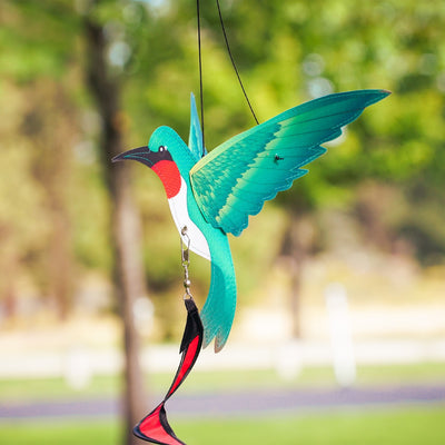 Hummingbird Theme Twister with moveable wings and curlie tail hanging in a garden, displaying vibrant colors and 3D design.