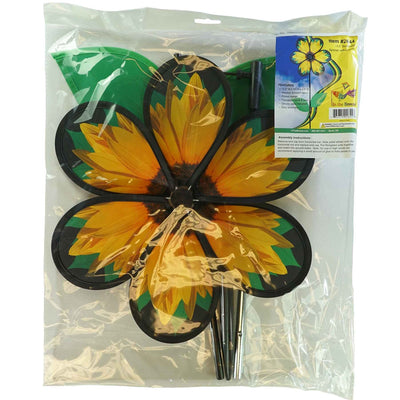 Alt Text: 13.5" sunflower spinner with six petals and green leaves displayed in a garden, twisting gently in the breeze on a fiberglass pole.