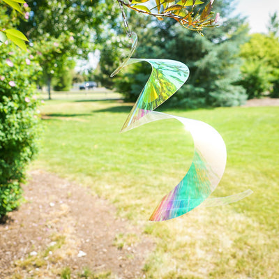 Alt Text: "30-inch iridescent twister tail made of Mylar, spinning gracefully in the sunlight, showcasing vibrant colors and reflections in an outdoor setting.