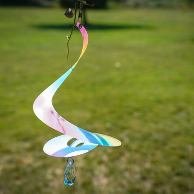 Alt Text: 8" Striped Iridescent Tear Drop Curlie with attached crystal spinner, displaying vibrant colors while hanging outdoors in a sunshine-filled garden.