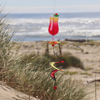 Alt Text = "Mini Cocktail 5 O'Clock Drink Spinner featuring a colorful cocktail glass design with a curlie tail, spinning in a garden setting.