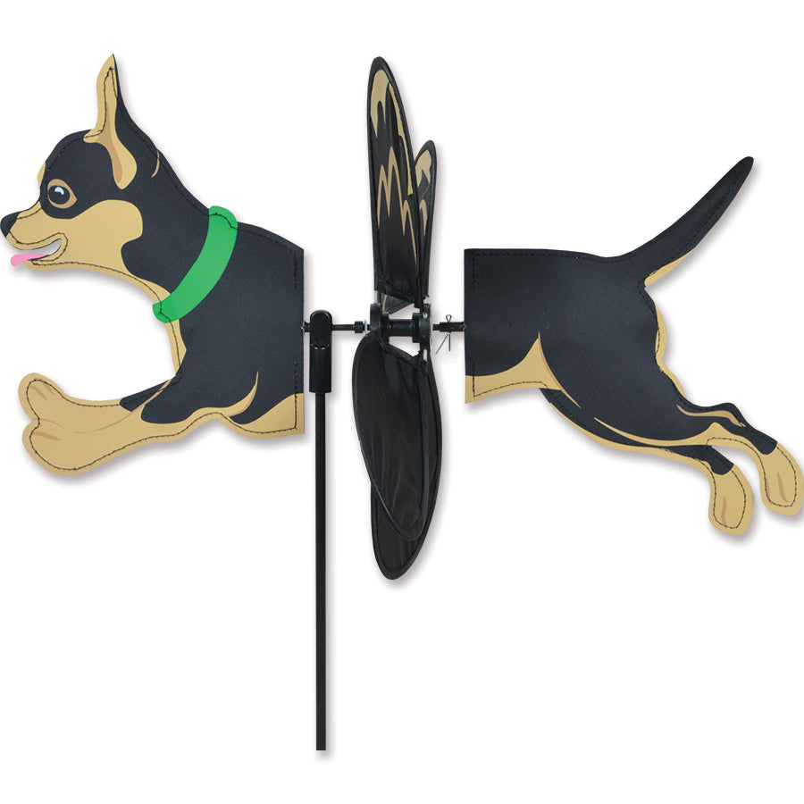 Alt Text: "Petite Spinner featuring a black and tan Chihuahua design spinning delightfully in a garden setting under sunlight.