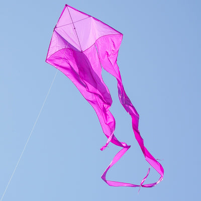 Alt Text: Purple 52" Wave Delta Kite soaring high in the sky, showcasing flowing tails and a vibrant color against a clear background.