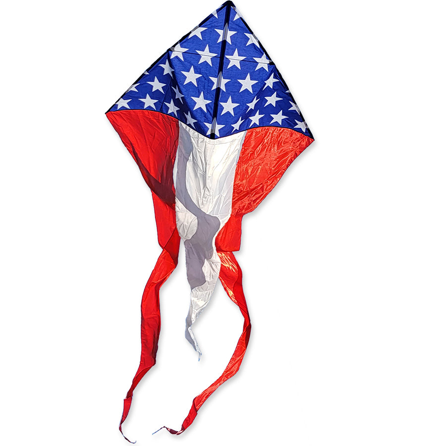 Alt text: 56 in. Flo-Tail Delta Kite featuring long, flowing patriotic tails displayed in the sky, flying high against a clear blue background.