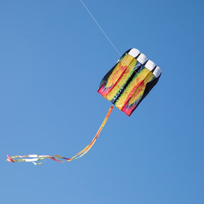 Alt Text: 7.5 Tie Dye Black Air Foil Kite flying against a clear blue sky, showcasing its vivid tie dye pattern and colorful tails in motion.