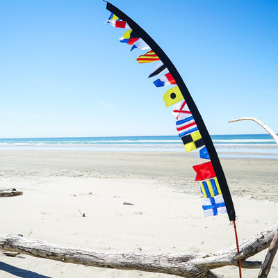 Alt Text: 8-foot Signal Flag Pennant Banner showcasing vibrant colored flags fluttering on a pole, ideal for events and businesses.