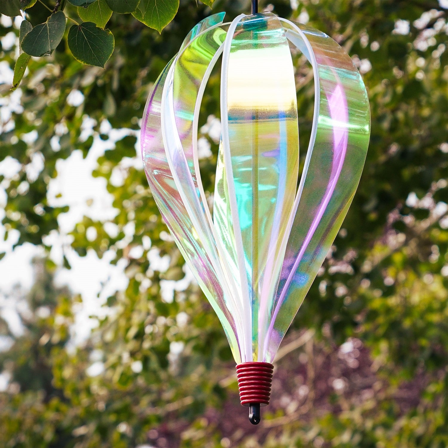 Iridescent 6-Panel Hot Air Balloon spinner gracefully spinning in an outdoor garden setting, showcasing its vibrant and colorful panels.