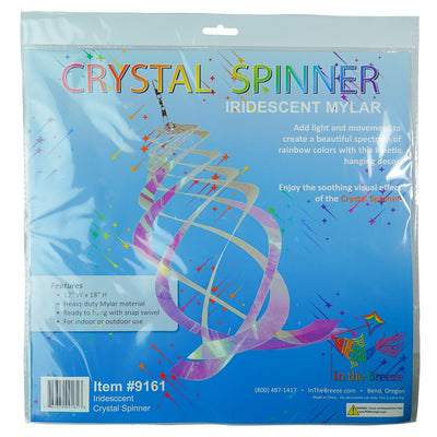 Iridescent Crystal Spinner made of Mylar, featuring five blades that spin smoothly in the breeze, creating a colorful display in a garden setting.