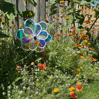 13.5-inch iridescent double flower spinner featuring two colorful flowers on a fiberglass pole, gracefully spinning in a garden setting.