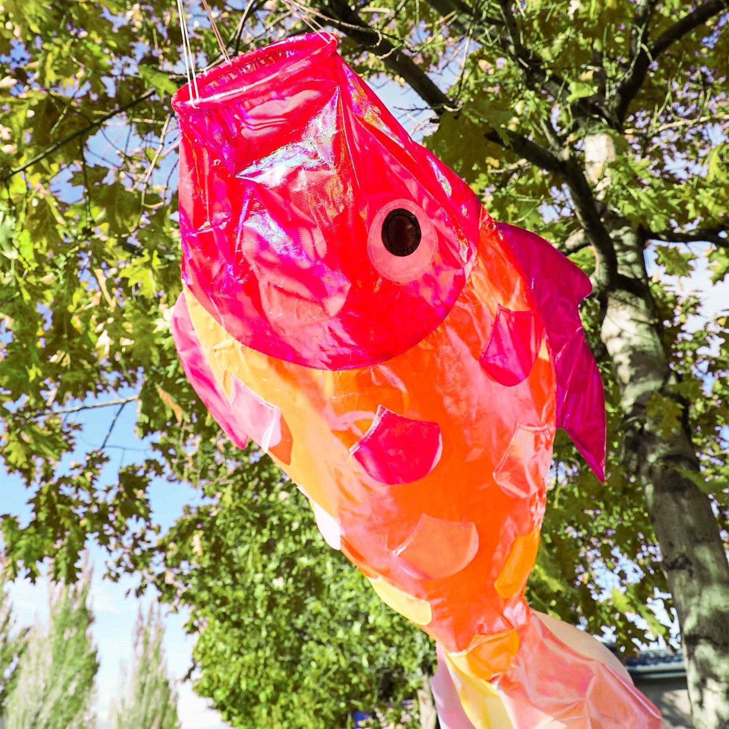 48 inch iridescent hot damsel fish windsock featuring colorful shimmering scales and an applique design hanging gracefully outdoors.