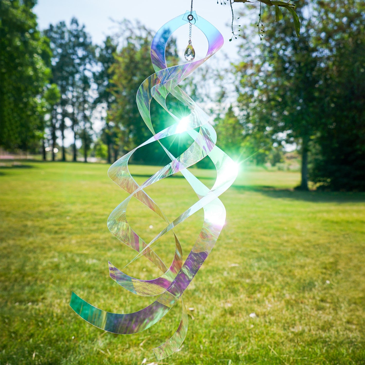 Iridescent Mylar Spin Quartet with Crystal spinning gracefully on a garden hook against a bright blue sky, showcasing vibrant colors and sparkles.