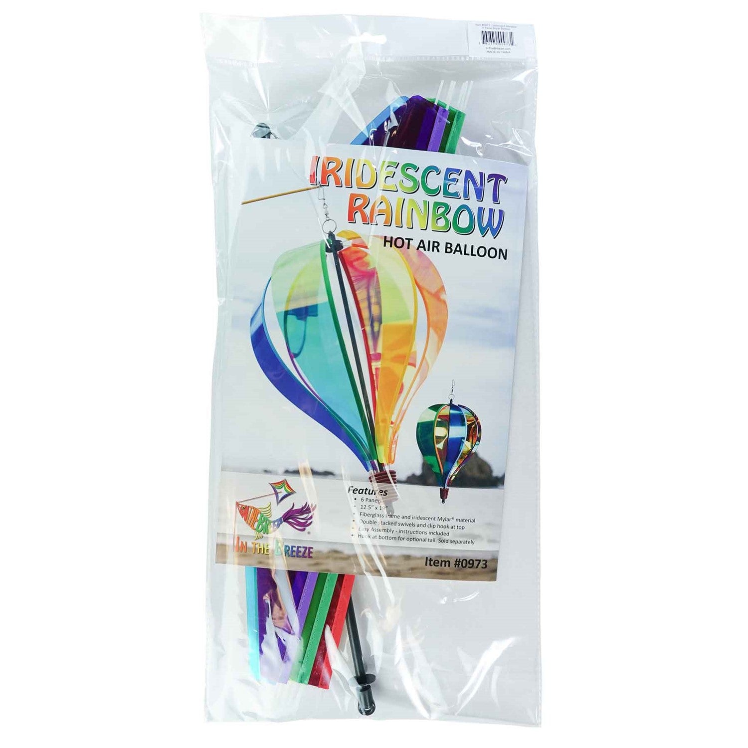 Iridescent Rainbow 6-Panel Hot Air Balloon spinner in vibrant colors, gently rotating in an outdoor garden setting.
