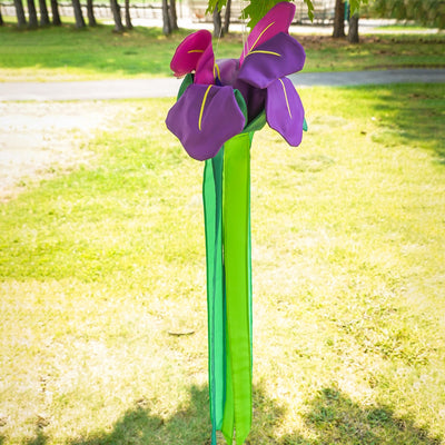 Iris Windtail features vibrant 3D iris flowers with colorful tails, gracefully hanging outdoors and rustling in the wind.