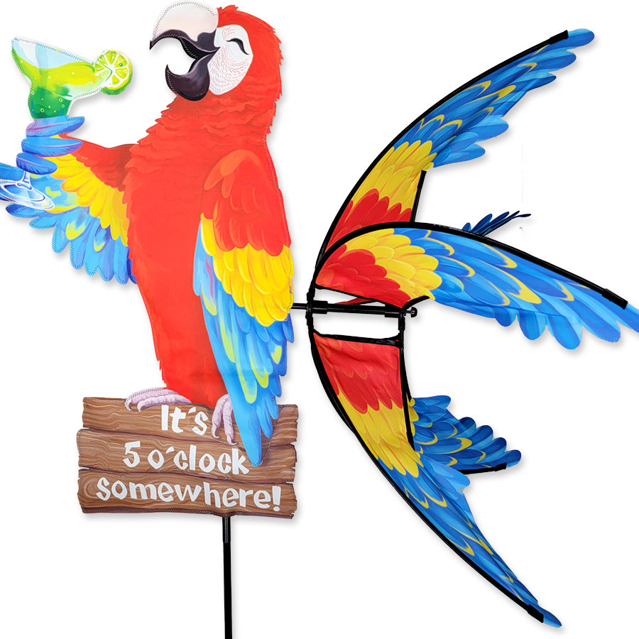 Colorful 37 in. Island Parrot Spinner with vibrant graphics displaying 'It's 5 o'clock somewhere!' spinning in the breeze in a yard setting.