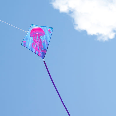 Jellyfish 30" Diamond Kite soaring against the blue sky with vibrant colors and tails, designed for easy flying.