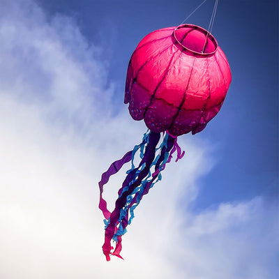 Colorful Jellyfish Big Breeze WindsockTM with flowing tentacles swaying in the wind, displayed in an outdoor setting to enhance the atmosphere.
