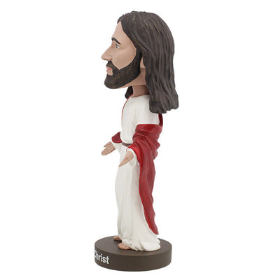 Hand-painted Jesus Christ Bobblehead made of heavyweight polyresin, showcasing intricate details, displayed indoors on a shelf.