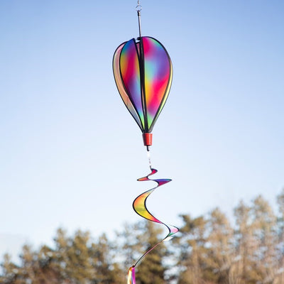 Jewel 6-Panel Hot Air Balloon spinner featuring a rainbow design, spinning gently in the breeze against a clear blue sky outdoors.