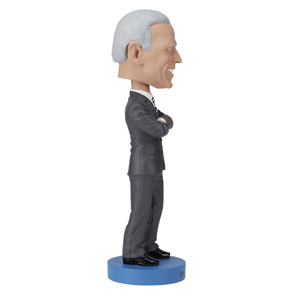 Joe Biden bobblehead standing over 8 inches tall, hand-painted with authentic details, displayed on a colorful shelf against a neutral background.