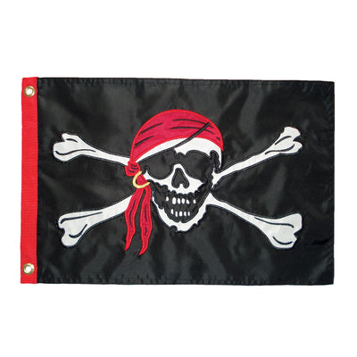 Jolly Roger Applique 12x18 Grommet Flag featuring a bold skull and crossbones design, displayed outdoors on a flagpole against a clear sky.