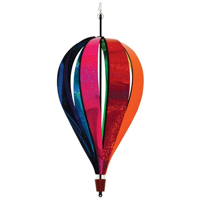 Jumbo Rainbow Glitter 8-Panel Hot Air Balloon spinning in outdoor garden, showcasing vibrant Mylar panels in rainbow colors.
