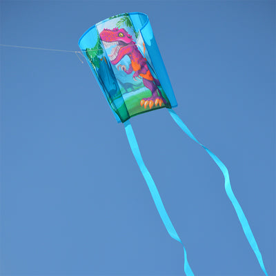 A colorful Keychain Kite - T-Rex with streamers flying in a blue sky, showcasing its fun design and compact size of 18 x 12.75 inches.