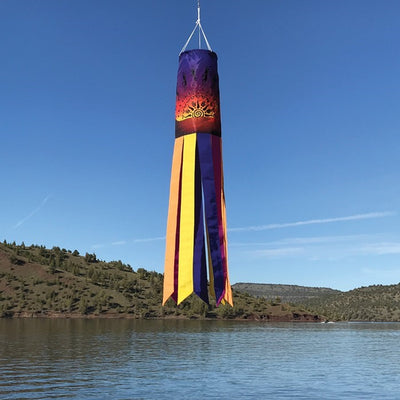 Colorful Kokopelli Sunset 40-inch windsock with embroidered details, fluttering in the breeze, adding vibrant art to outdoor space.
