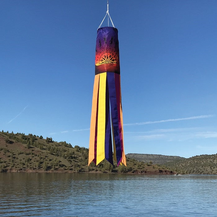 Colorful Kokopelli Sunset 40-inch windsock with embroidered details, fluttering in the breeze, adding vibrant art to outdoor space.