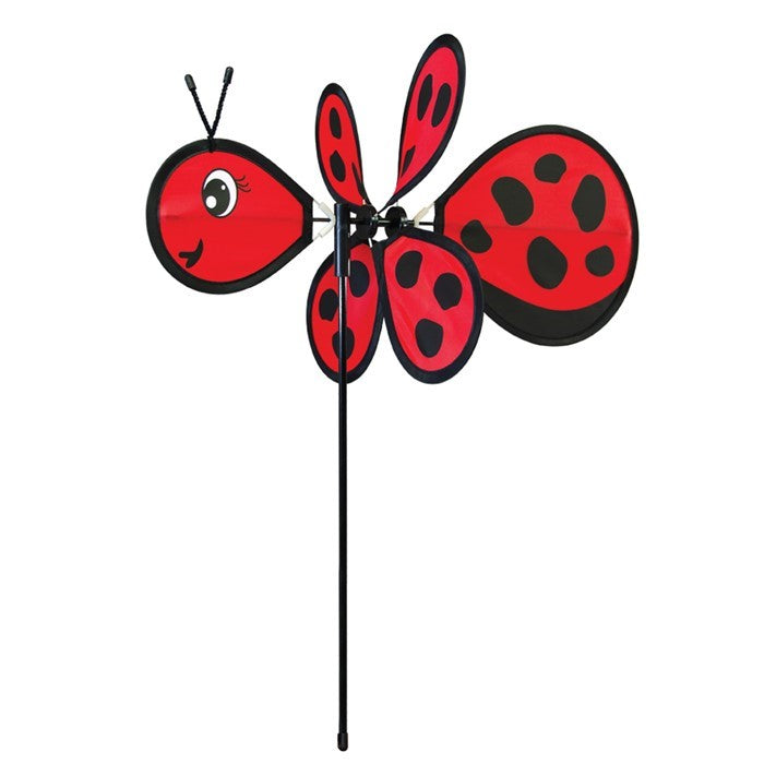 Ladybug Baby Spinner featuring a colorful 12-inch wheel on a sturdy fiberglass pole, designed for lively outdoor decoration in a garden setting.