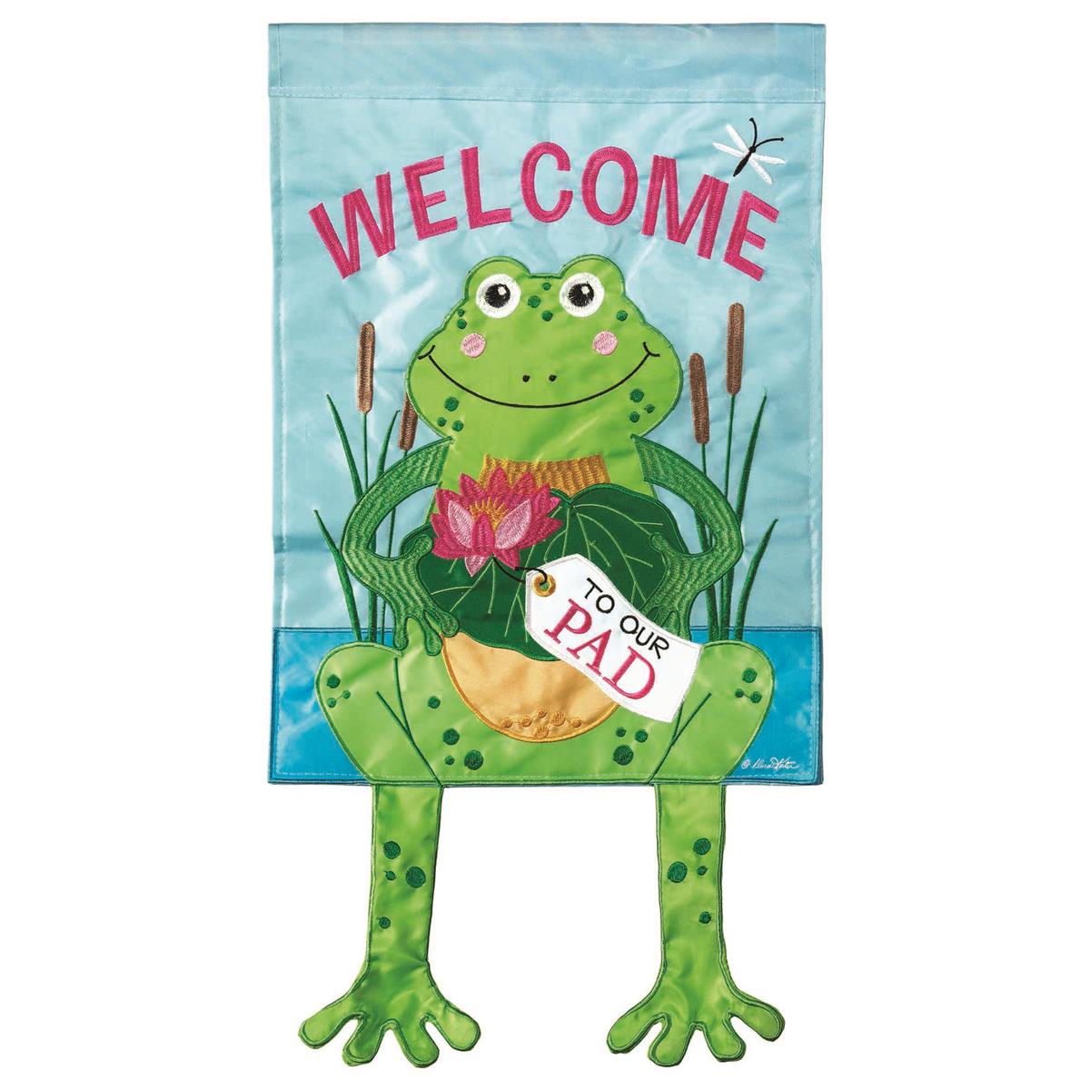 Large Crazy Leg Frog Welcome Banner Flag showcasing a whimsical frog design with dangling legs, displayed outdoors in a garden setting.