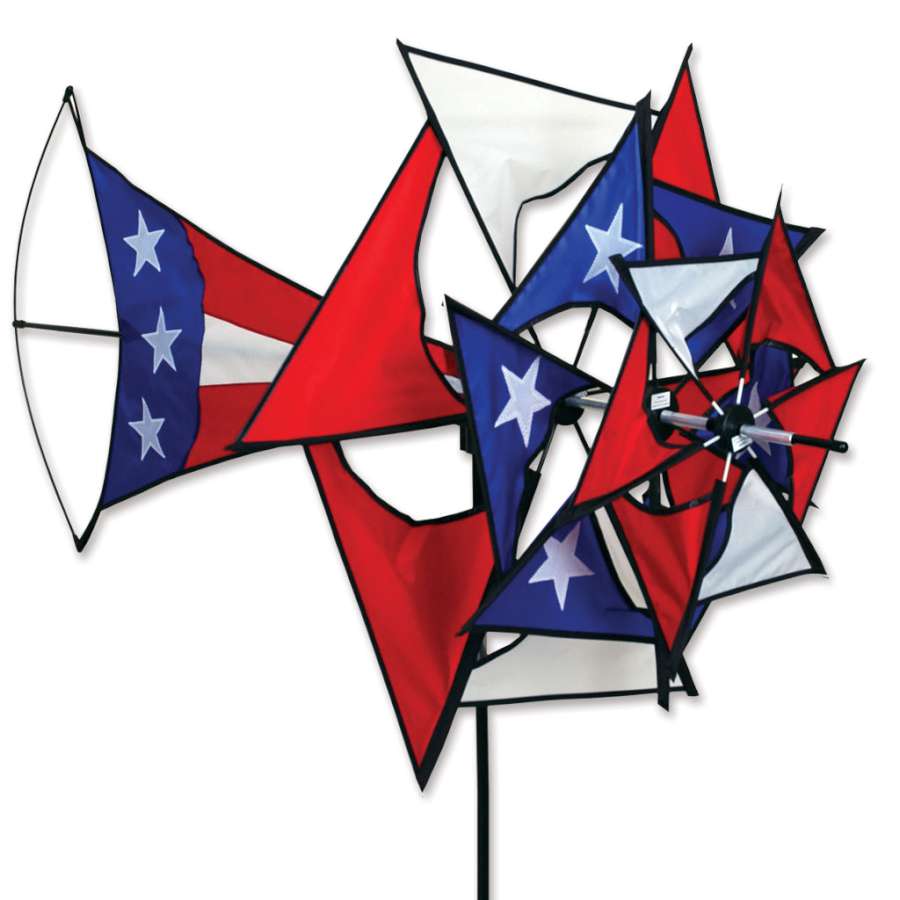 Large Patriotic Windmill featuring red, white, and blue colors, rotating blades, and stars and stripes design displayed in a sunny garden setting.