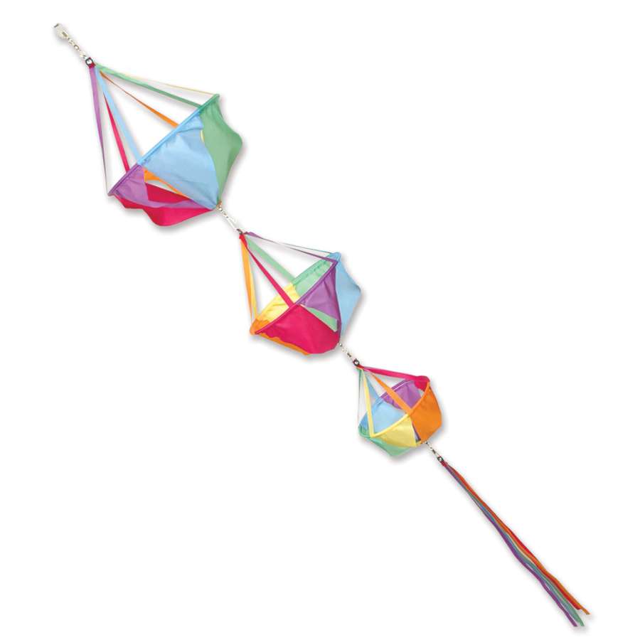 Large Spinnie Set - Circus featuring colorful designs spinning in a light breeze, set against a lush outdoor garden environment.